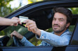 © auremar - man taking ticket to pass control on parking area