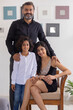 © IndiaPix - Portrait of happy couple with their child posing in front of camera at home