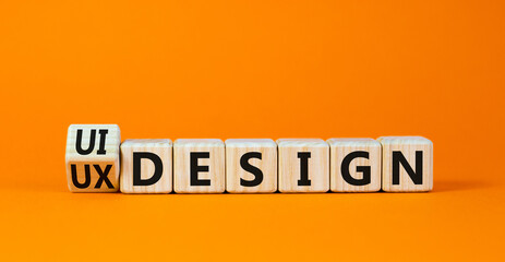 UX user experience design or UI user interface design symbol. Turned wooden cubes and changed words UX design to UI design. Beautiful orange background. Business UX or UI design concept. Copy space.