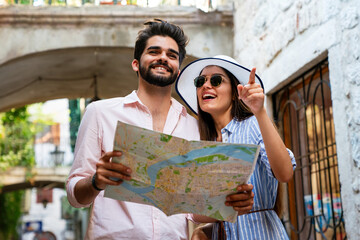 Wall Mural - Holiday travel vacation love and friendship concept. Smiling couple having fun together in city