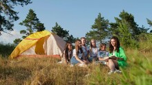 The Camp Counselorr Works With A Group Of Children Outdoors, The Children Are Resting In A Tent