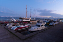 Boats, Yachts In The Harbor Against The Backdrop Of Snow-capped Mountains At Dusk, Batumi