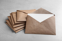 Many Brown Paper Envelopes On Light Grey Table