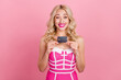 © deagreez - Portrait of attractive cheerful girly funny wavy-haired girl holding in hand nfc card isolated over pink pastel color background