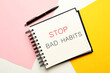 © New Africa - Notebook with phrase Stop Bad Habits and pen on color background, flat lay