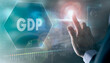© Duncan Andison - A businessman controlling a futuristic display with a GDP business concept on it.