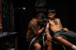 © ADDICTIVE STOCK - Peruvian tattooist making tattoo on arm of man