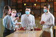 © davit85 - The waiters of the restaurant in a medical mask learns to distinguish between the glasses.