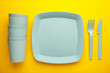 © Mouse family - Bright plastic disposable tableware on yellow background.