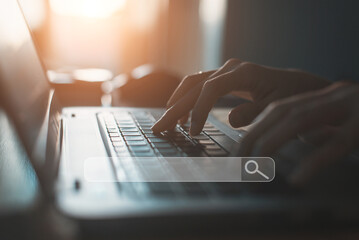  People hand using laptop or computor searching for information in internet online society web with search box icon and copyspace.
