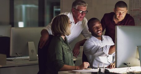 Reviewing their big plans together. 4k video of a group of businesspeople working late on a computer in an office.