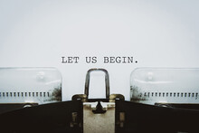"Let Us Begin" Text Typed On A Vintage Typewriter