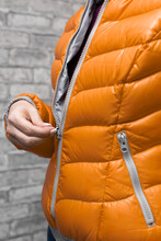 Woman Zips Up Her Warm Red Jacket
