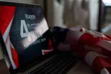 Laptop With Inscription 4 July Inscription Over American Flag. Independence Day.