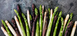 Green, white and purple asparagus on a kitchen background