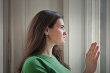 Portrait Of Young Woman While Looking Out The Window
