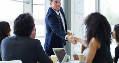 Wall Mural - The boss is here to show them how business is done. 4k video footage of a businessman shaking hands with colleagues before giving a presentation in an office.