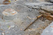 Underground Rusty Broken Pipe And Sewer Manhole Exposed During Street Repair On Uptown Neighborhood Street In New Orleans, LA, USA