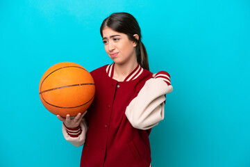 Wall Mural - Young caucasian basketball player woman isolated on blue background suffering from pain in shoulder for having made an effort