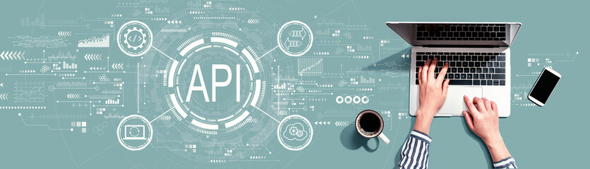 api - application programming interface concept with person using a laptop computer