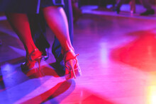 Dancing Shoes Of A Couple, Couples Dancing Traditional Latin Argentinian Dance Milonga In The Ballroom, Tango Salsa Bachata Kizomba Lesson, Festival On A Wooden Floor, Purple, Red And Violet Lights