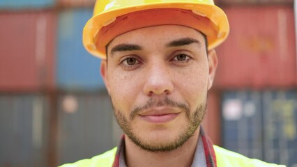 Wall Mural - Engineer young industrial worker man looking at camera at shipping freight terminal port