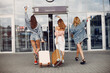 Three beautiful girls standing by the airport