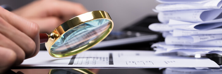 Poster - Businessperson Looking At Invoice Through Magnifying Glass