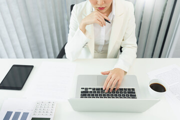 Confidence woman concept, Businesswoman is thinking strategy of business and typing data on laptop