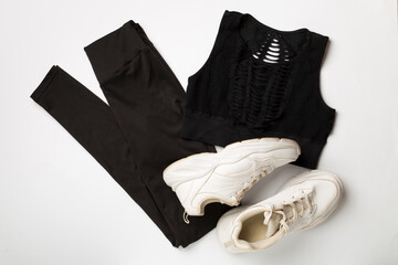 Flat lay composition with sport clothes on white background, top view