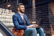 © ivanko80 - Man using laptop on a sunny day