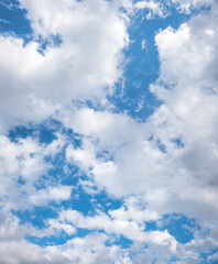 Wall Mural - broken cloud cover and blue sky, vertical