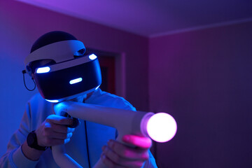 Wall Mural - man with virtual reality headset and joystic is playing game
