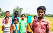© WESTOCK - Happy smiling village kid showing green screen mobile phone in front children by looking camera - concept of education, app advertisement for lerning and technology.