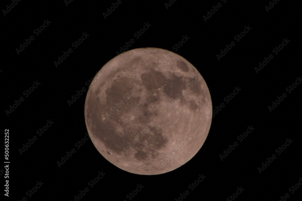 The full moon by a 500mm telephoto lens. Stock Photo | Adobe Stock