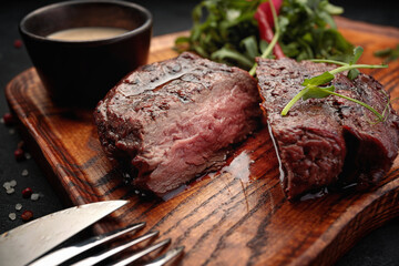 Wall Mural - Meat steak on the wooden board, with fork and knife