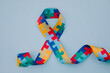 Colorful ribbon on blue background. World autism awareness day concept