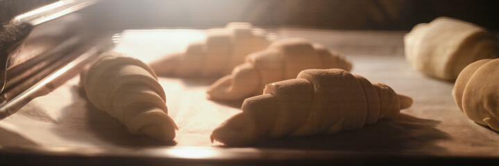 Cooking sweet tasty croissants in oven closeup