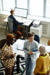 © Seventyfour - Vertical high angle portrait of three creative young people chatting during coffee break in office
