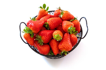 Wall Mural - top view of strawberries in basket on white background