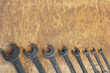 Set of old wrenches on wooden background