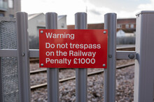 Warning Sign Next To Train Tracks Informing The Public Not To Trespass On The Railway Which Could Lead To A Penalty Fine
