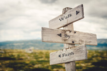 Walk By Faith Text Quote Written In Wooden Signpost Outdoors In Nature. Moody Theme Feeling.