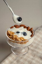 Yogurt With Blueberries, Almonds And Cereals. And A Spoonful Of Blueberries.