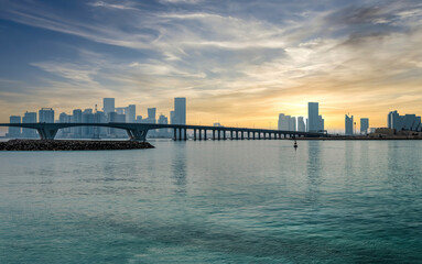 abu dhabi, united arab emirates - february 2022: panoramic abu dhabi city skyline with a bridge duri