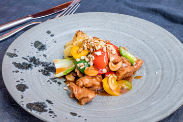 Wall Mural - Pork in sweet and sour sauce with cashew on grey plate