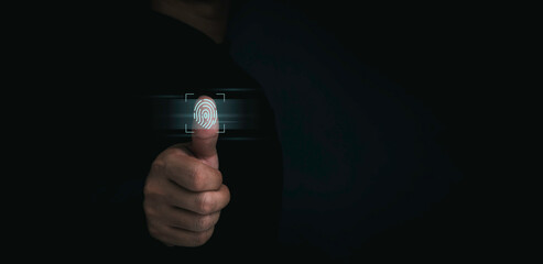 A fingerprint icon appeared while human thumb scanned for security access with biometrics identification on dark background with copy space. Business technology safety internet network concept.