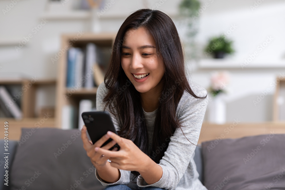 Happiness Entrepreneur beautiful business asian young woman wear casual use mobile phone for shopping online enjoy with social media and laptop at home.Small Business Startup.online banking