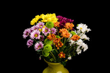 Bouquet Of Flowers In An Iodized Vase On Black Background