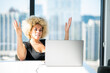 © terryleewhite - Young Light Skinned African-American Woman Throwing Her Hands Up While Looking at Laptop